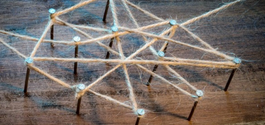 auf Nägeln in holz ein Netz aus Strick geschlungen